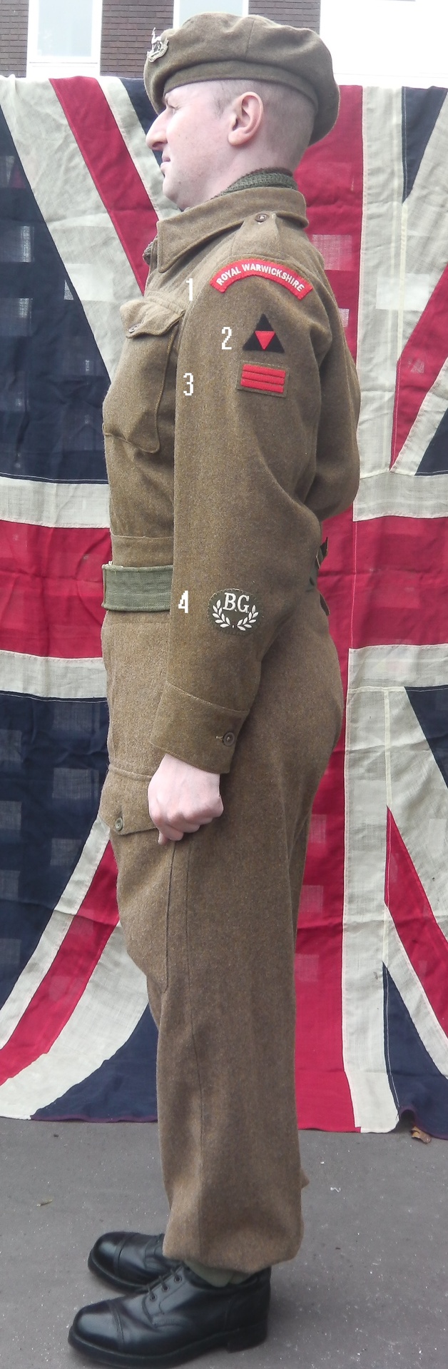 Re-enactor wearing battledress, showing left-arm insignia